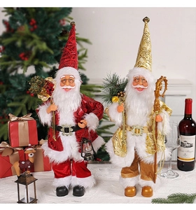 Detailed view of standing Santa Claus dolls in red and gold festive outfits for decoration