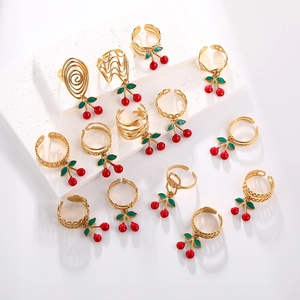 Set of gold stainless steel cherry rings with red enamel pendants in various band styles