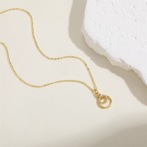 Close-up of interlocking circles pendant with sparkling cubic zirconia on a gold chain