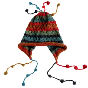 Colorful striped knit beanie with earflaps and vibrant tassel balls for winter