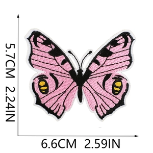 Pink butterfly embroidered patch showing measurements 6.6cm x 5.7cm on white backdrop