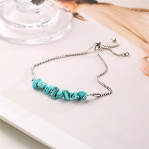 Detail of adjustable silver chain bracelet with natural blue turquoise stone chips