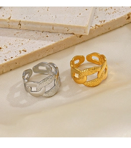 Detailed view of gold and silver chain rings with hammered texture on travertine stone