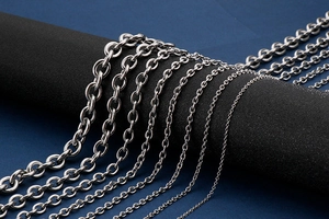 Detail shot of various thick silver stainless steel O-chains and cross links for men