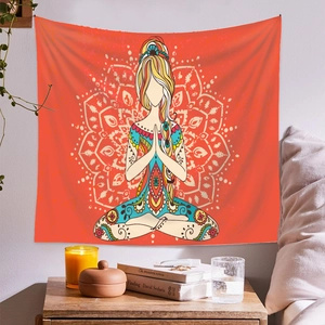 Detail of a meditation yoga tapestry with vibrant red mandala art in a cozy room setting