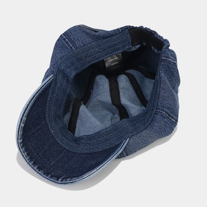 Interior view of blue washed denim newsboy cap featuring 100% cotton and adjustable band