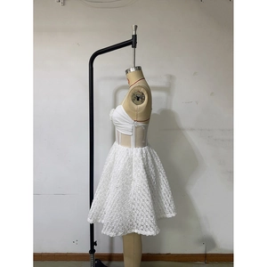 Detail of white mini dress featuring 3D rose floral lace and corset style bodice