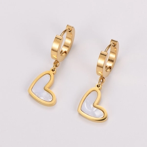 Macro shot of gold heart earrings with white mother-of-pearl inlay for women