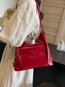 Chic red faux leather tote bag with a bow detail, stylish multi-use backpack for women