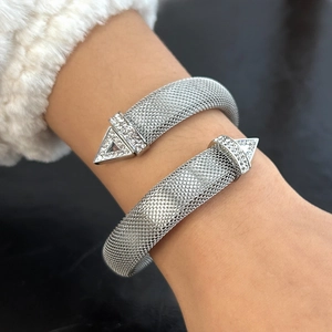 Elegant silver mesh open bangle with sparkling rhinestone triangle ends on woman's wrist