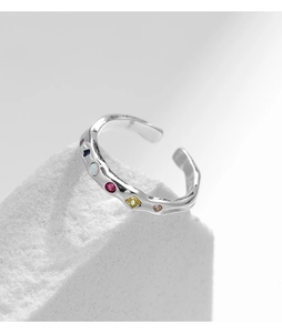 Detail of 925 sterling silver liquid geometric ring with colorful gemstones