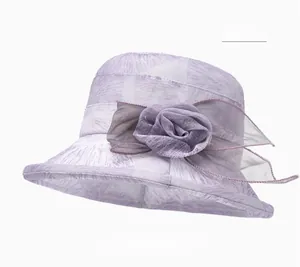 Detail of purple sun hat featuring elegant mesh floral decor and textured breathable fabric