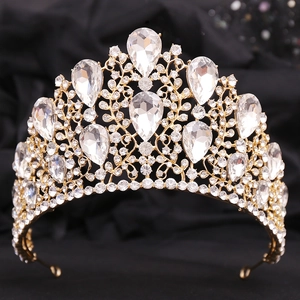 Close-up of golden baroque bridal crown with sparkling water-drop rhinestones and crystals