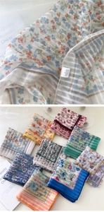 Detailed texture of cotton linen floral scarf with close-up of material composition label