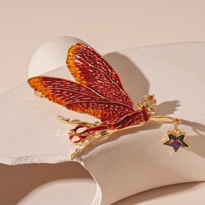 Vintage fairy brooch with red-orange enamel wings and a hanging star zircon charm