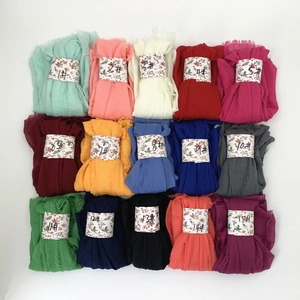 Flat lay of 15 colorful pleated cotton viscose scarves with numeric paper band labels