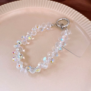 Macro detail of clear rainbow crystal beads on a phone strap with silver clasp