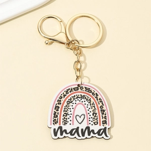Detail of mama leopard print rainbow keychain with gold ring and engraved wooden pendant