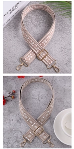 Detail of bohemian jacquard woven bag straps with gold metal hooks and geometric patterns