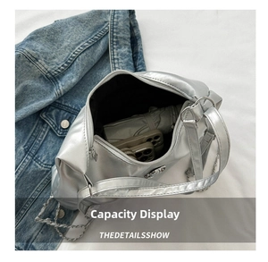 Silver metallic crossbody bag interior showing large capacity for umbrella and phone
