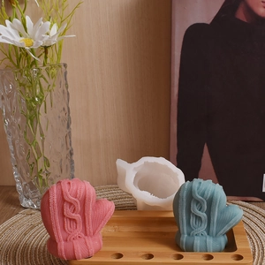 Detail of DIY candle silicone mold showing realistic knitted wool glove texture with crafts