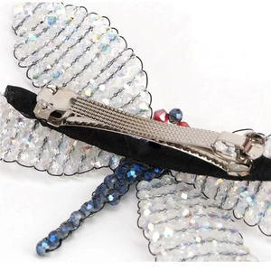 Macro shot of dragonfly hair clip back showing beaded structure and metal spring clip