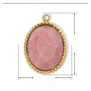 Macro detail of oval natural stone pendant with golden stainless steel beaded frame