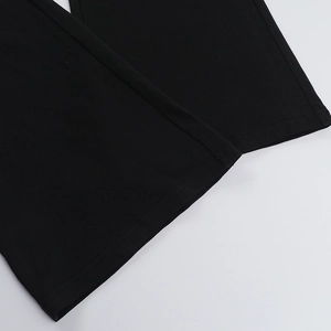 Macro detail of high-quality knit fabric texture and hem stitching on black jumpsuit