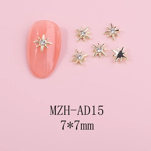 Detailed close-up of 7x7mm gold alloy star nail charms with center rhinestone on pink background