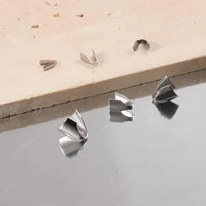 Polished silver stainless steel end clips and flat blade chain connectors on stone
