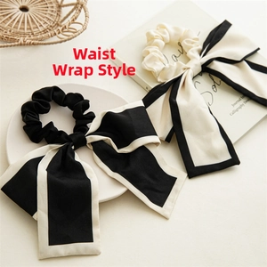 Close-up of elegant black and beige chiffon scrunchies with long ribbons and contrast borders