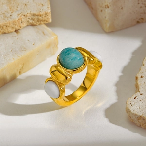 Detailed macro view of vintage gold ring featuring a large oval teal gemstone and white gems