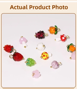Detailed view of colorful glass fruit charms like strawberries and grapes for DIY jewelry