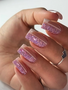 Detailed close-up of pink and purple glitter gradient French square press-on nails