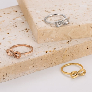 Infinity symbol rings in gold, silver, and rose gold with pavé set crystals