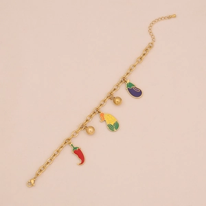 Detail of gold chain necklace with colorful enamel chili, corn, and eggplant pendants
