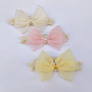 Detailed view of baby headbands with tulle bows, lace bands and rhinestone crowns