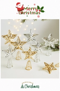 Close-up of gold and silver hollow star tree toppers with spring base for Christmas decor