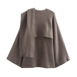 Close-up of brown wool knitted cloak with matching scarf showing rich fabric texture