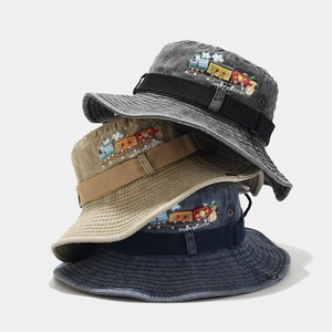 Detailed embroidery of train motif on vintage washed canvas bucket hats for kids