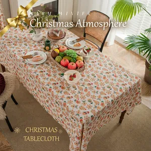 Christmas tablecloth with gingerbread man and Santa patterns on warm beige linen fabric