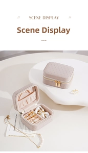 Detail view of the mini travel jewelry box with quilted leather and golden dual zippers