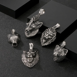Detailed close-up of vintage punk lion, wolf and bear head pendants in silver steel