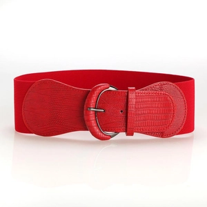 Detail of red elastic waist belt featuring a crocodile pattern leather buckle with metal ring