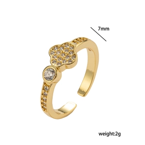 Detailansicht des goldenen Kleeblatt-Rings mit Zirkonia-Steinen auf weißem Hintergrund