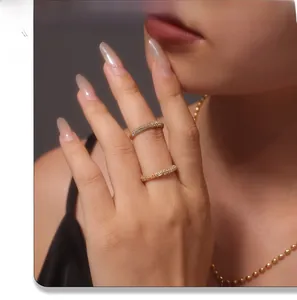 Close-up of dual gold-plated stainless steel rings with sparkling cubic zirconia inlay