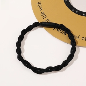 Detail of a black braided hair tie with a durable elastic three-strand woven design