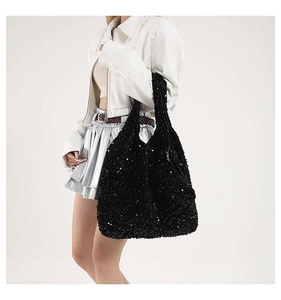 Detailed close-up showing the shimmering black sequin texture of this large tote bag