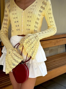 Slim fit hollow-out knit cardigan with flared sleeves and white buttons in light yellow