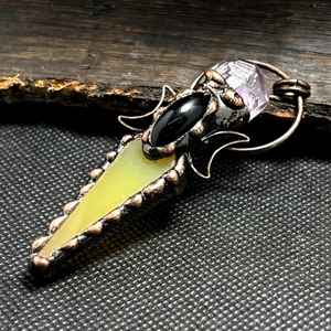 Macro view of vintage bronze wire-wrapped agate and amethyst stone sweater necklace